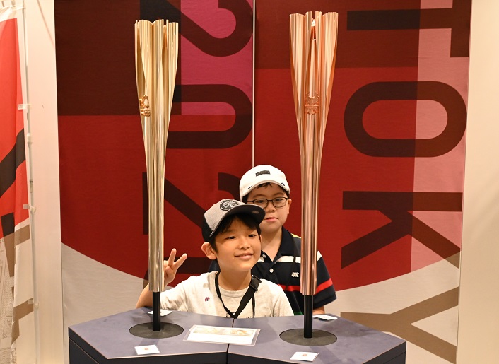 Children looking at torches of the “Torch Relay”