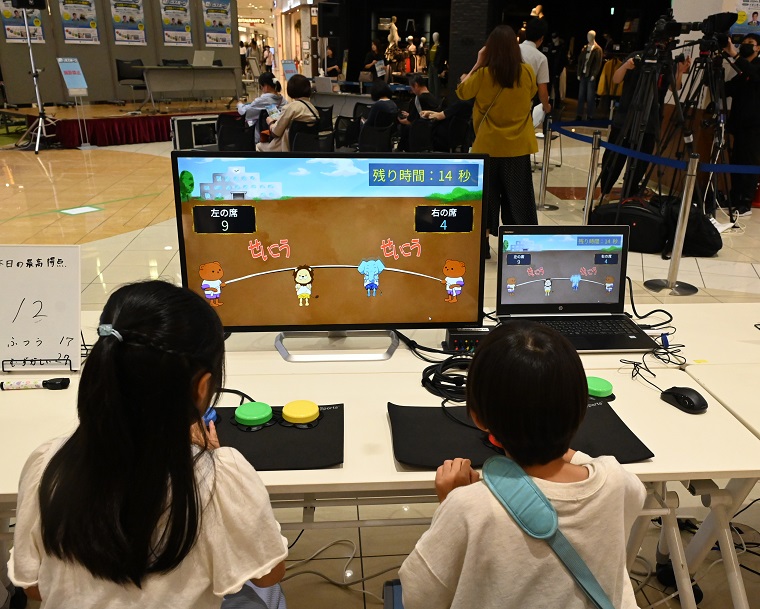 participants playing a game while watching a monitor in the exchange meeting
